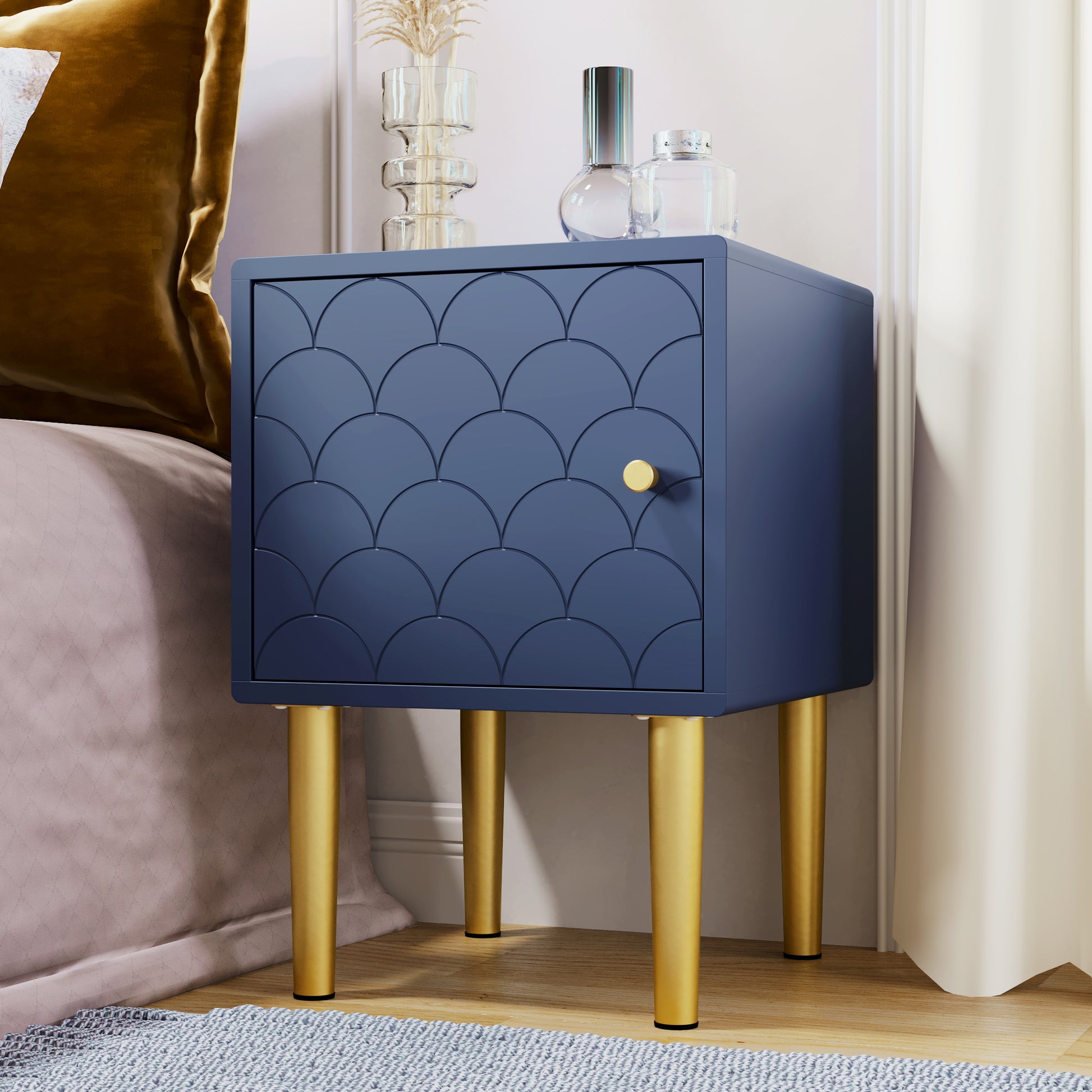 Blue nightstand with gold legs in a bedroom setting
