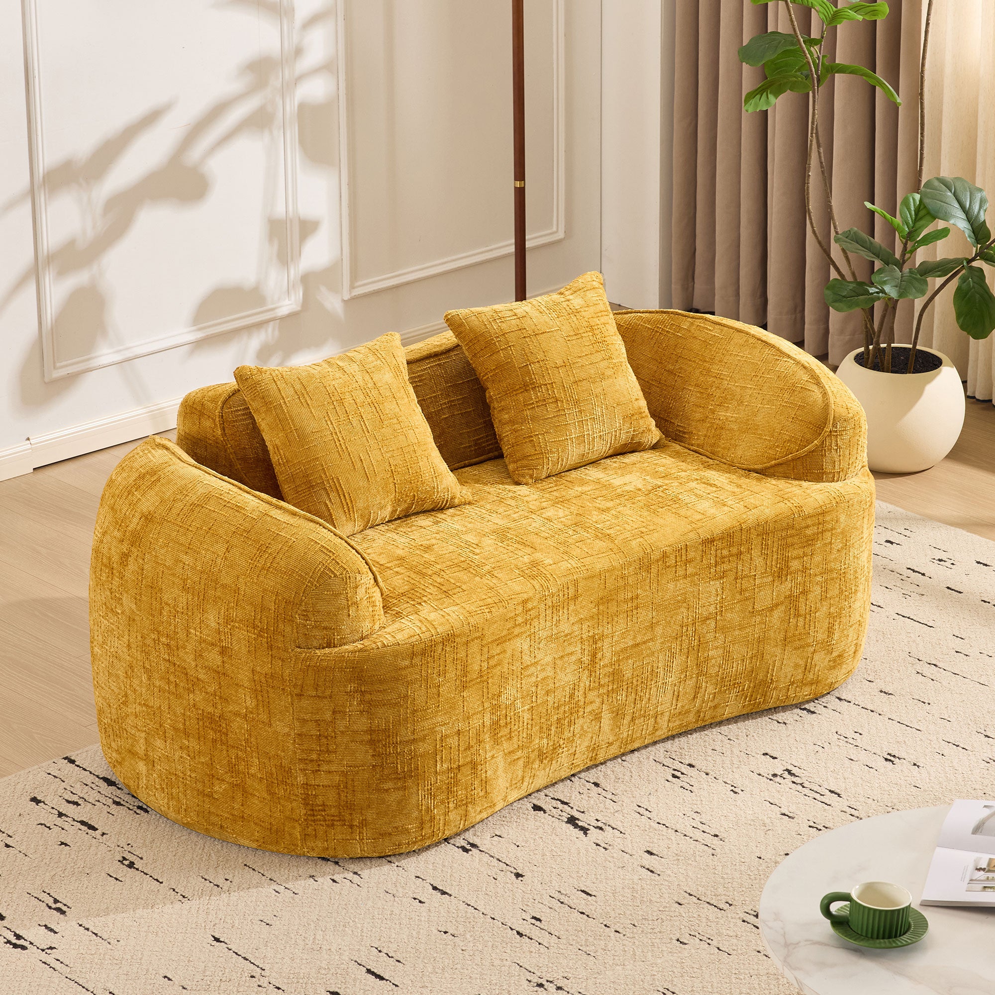 Yellow curved two-seater sofa with armrests and 2 cushions, cream-colored