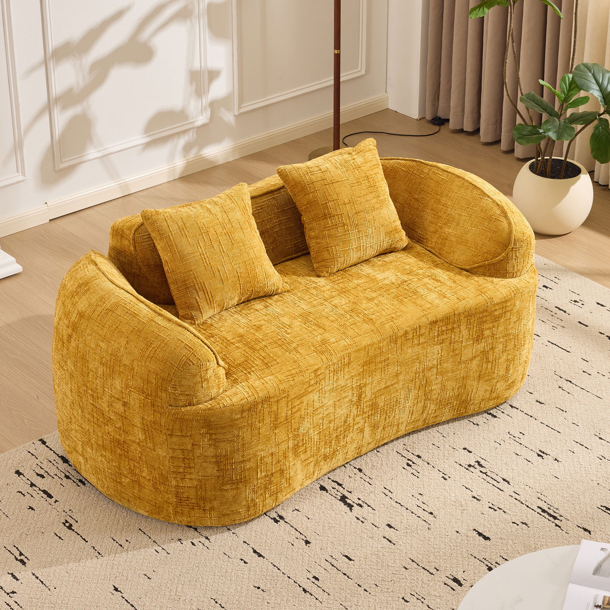 Yellow curved two-seater sofa with armrests and 2 cushions, cream-colored